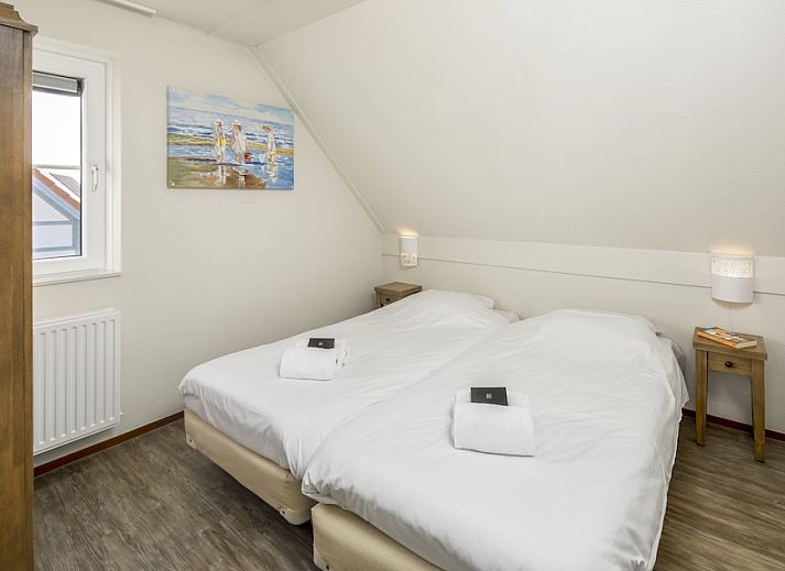 Villa 5A in Cadzand-bad, Zeeuws-Vlaanderen, Zeeland, een charmant vakantiehuis met rode daken en groene omgeving.