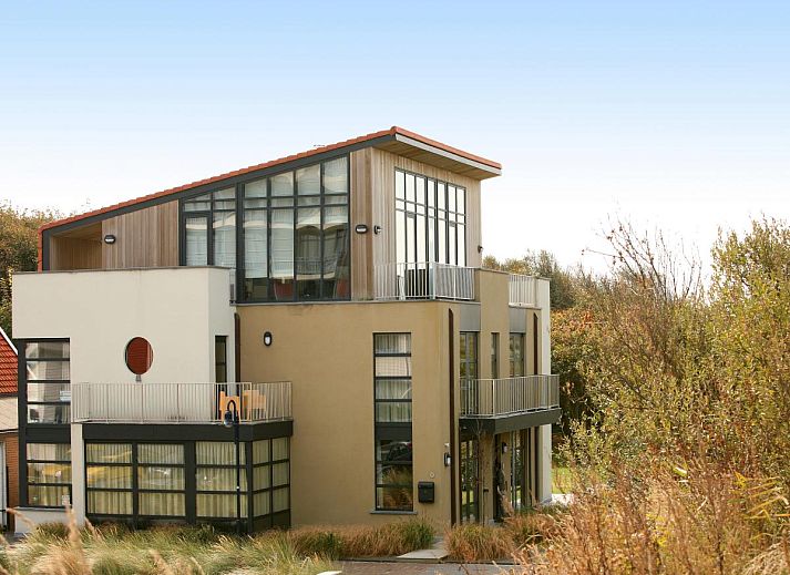 Gezellige zithoek in vakantiehuis Maanvis, Cadzand, met comfortabele meubels en televisie.