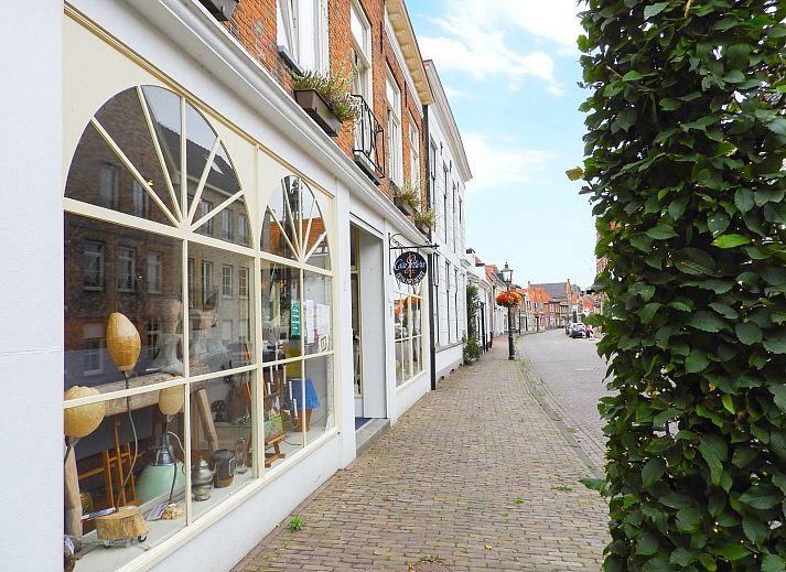 Exterior of VZ052 Apartment Sluis in Sluis, Zeeuws-Vlaanderen, surrounded by lush garden.