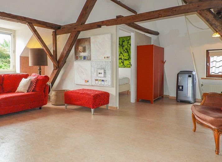 Cozy garden at VZ052 Apartment Sluis in Sluis, Zeeuws-Vlaanderen with parasol and seating area.