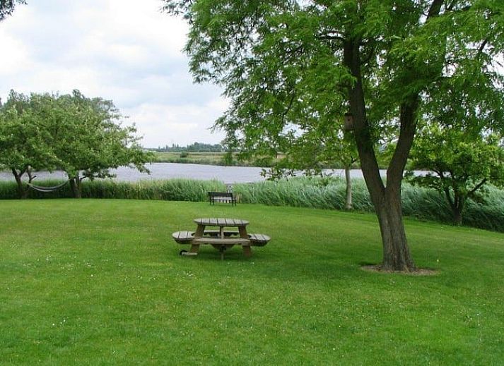 Blick auf die gruene Umgebung und den Fluss im Ferienhaus in Oostburg, ideal fuer Naturliebhaber in Zeeland.