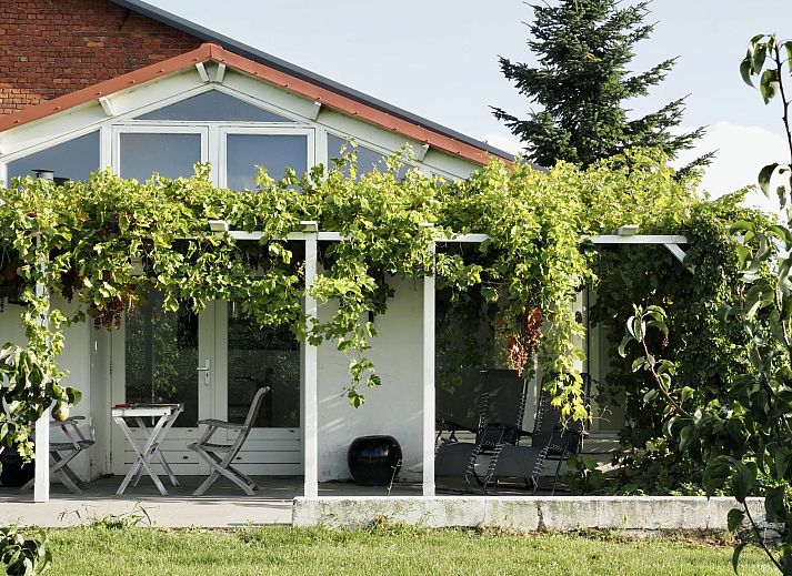 Charming exterior of Holiday Home De Orangerie in Zaamslag, Zeeuws-Vlaanderen, with a cozy patio.