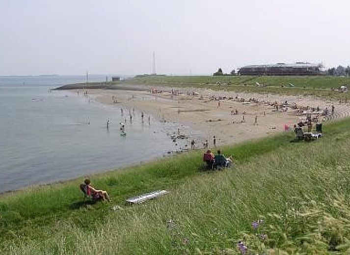 Spacious terrace at Vermare in Wemeldinge, South Beveland, with comfortable garden chairs and parasol.