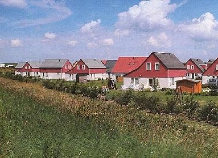 Spacious terrace at Vermare in Wemeldinge, South Beveland, with comfortable garden chairs and parasol.