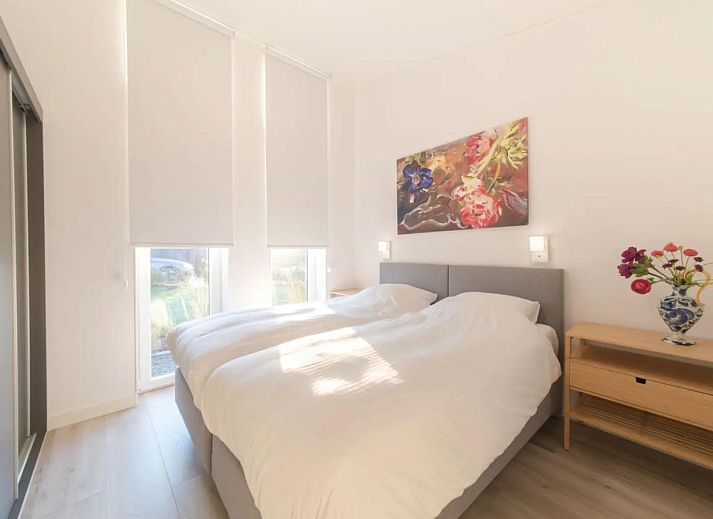 Bright living room of Holiday home Waterresort Oosterschelde house no. 73 in Wemeldinge, South Beveland with large windows.