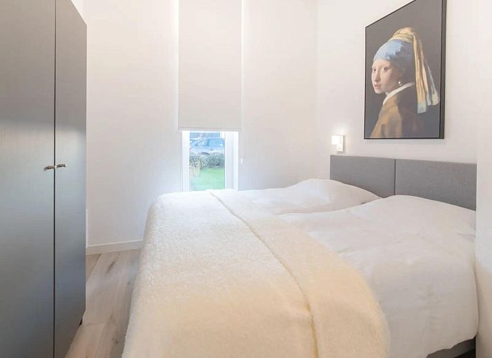 Bright living room of Holiday home Waterresort Oosterschelde house no. 73 in Wemeldinge, South Beveland with large windows.