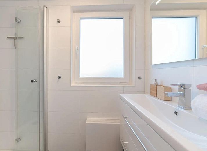 Bright living room of Holiday home Waterresort Oosterschelde house no. 73 in Wemeldinge, South Beveland with large windows.