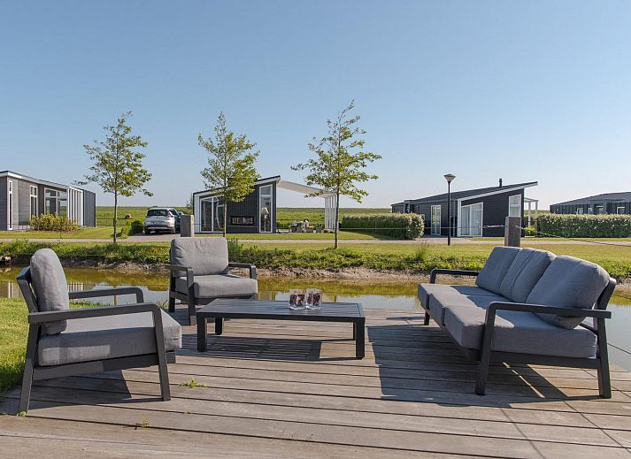 Bright living room of Holiday home Waterresort Oosterschelde - house no. 38 in Wemeldinge with comfortable furniture.
