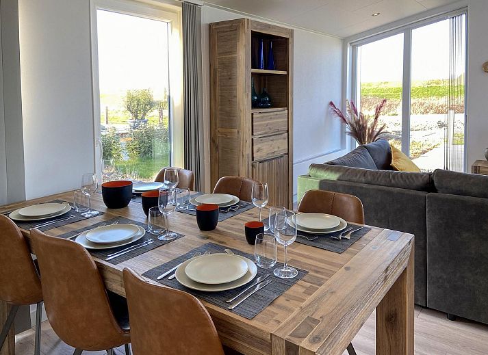 Gemuetliches Wohnzimmer im Ferienhaus Waterresort Oosterschelde Haus Nr. 83 in Wemeldinge, Zuid-Beveland, mit Blick auf den Garten.