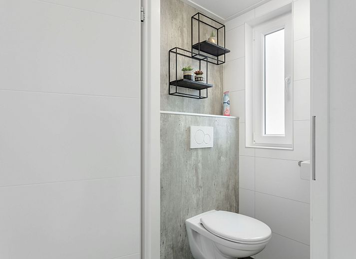 Eetkamer van Vakantiehuis Ruisweg 12, Wemeldinge, Zeeland, met stijlvolle eettafel en hanglampen, ideaal voor familiediners.