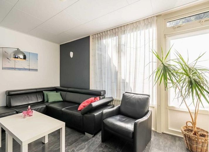 Cozy living room in vacation home Scheldeoord 54, Baarland, South Beveland, with comfortable seating area and natural light.