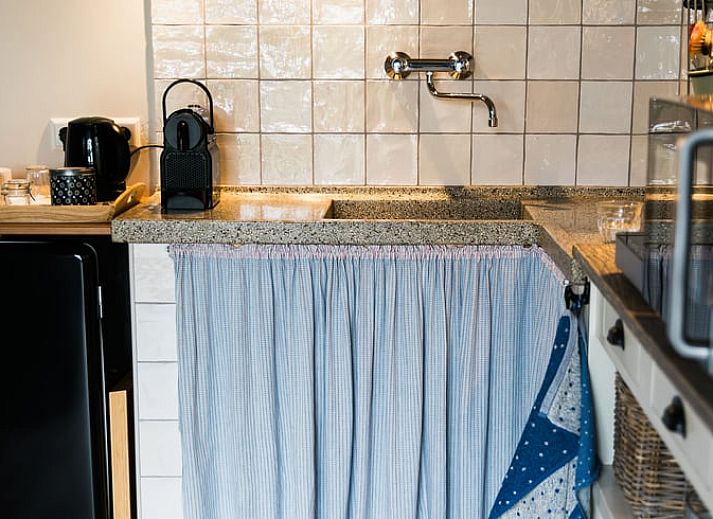 Buitenkant van Vakantiehuis in Lewedorp, Zuid-Beveland omgeven door groen en blauwe lucht.