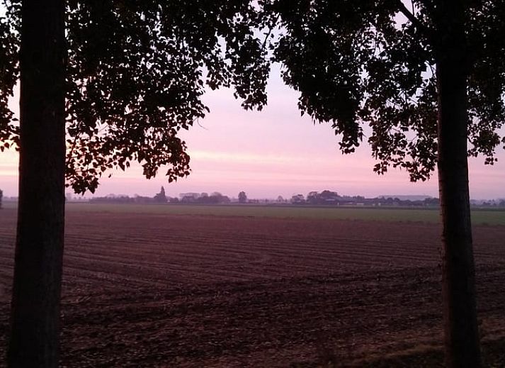 Gezellige woonkamer van Vakantiehuisje in Lewedorp, Zuid-Beveland, met uitzicht op de natuur en comfortabele zitruimte.