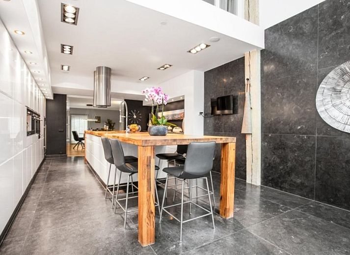 Elegant entrance to Het Vinkenest bungalow in Oud-Alblas, South Holland with modern glass details and stylish furnishings.