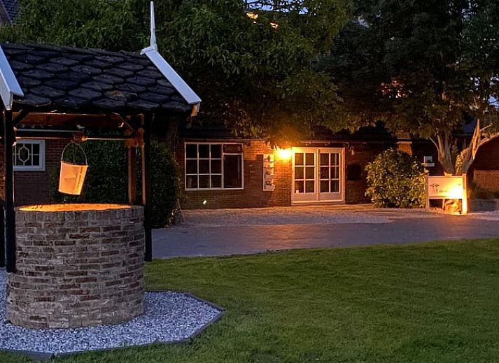Cozy living room in vacation home Streefkerk, with comfortable sofa and natural light.