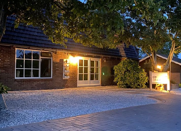 Cozy living room in vacation home Streefkerk, with comfortable sofa and natural light.