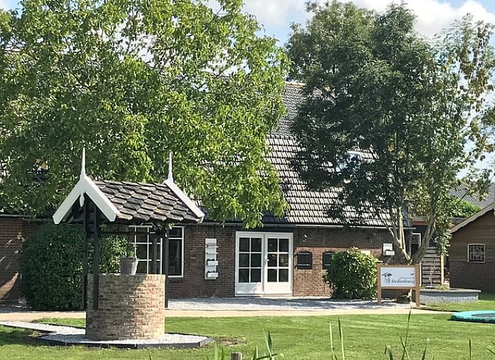 Open living space in vacation home Streefkerk, with dining area and stairs to upper floor.