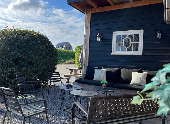 Open living space in vacation home Streefkerk, with dining area and stairs to upper floor.