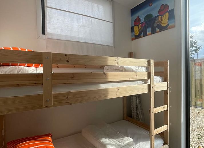 Veranda of House in Ouddorp, vacation accommodation in Ouddorp, South Holland with seating and green surroundings.