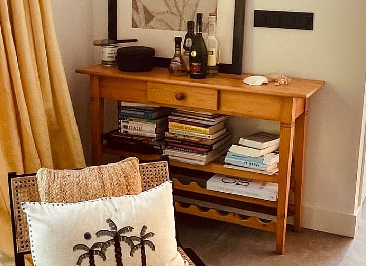 Veranda of House in Ouddorp, vacation accommodation in Ouddorp, South Holland with seating and green surroundings.