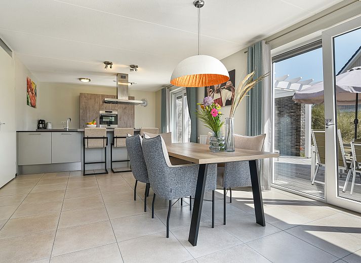 Modern furnished dining room in Strand Resort Ouddorp Duin, 6-person villa Springerduin, Ouddorp, South Holland, overlooking the terrace.