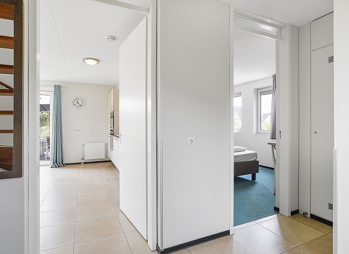 Strand Resort Ouddorp Duin villa in Ouddorp, South Holland overlooking dunes and blue sky.