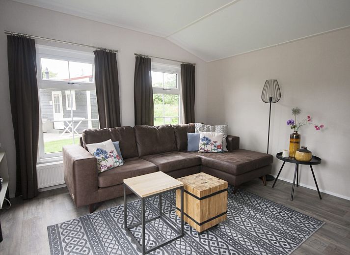 Gemuetlicher Innenbereich des Chalet Ouddorp in Goeree-Overflakkee, Suedholland. Gemuetliche Sitzecke und Esstisch in einem Ferienhaus.