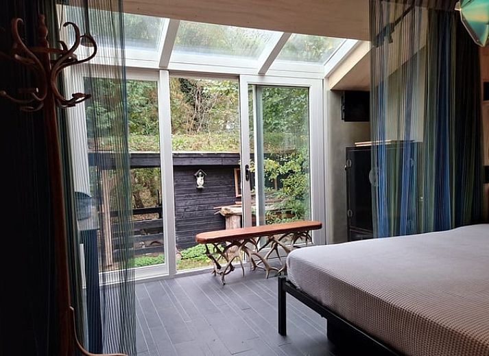 Cozy living room with wood stove in Holiday home in Ouddorp, South Holland.