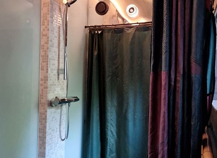 Cozy living room with wood stove in Holiday home in Ouddorp, South Holland.