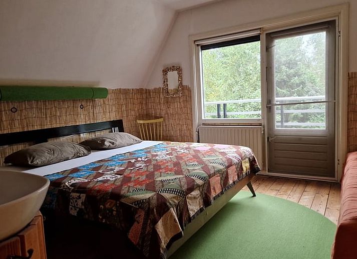 Bright conservatory overlooking garden in Holiday home in Ouddorp, Goeree-Overflakkee.