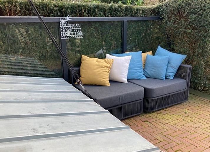 Dining area with wooden table in Holiday home in Ouddorp, South Holland.