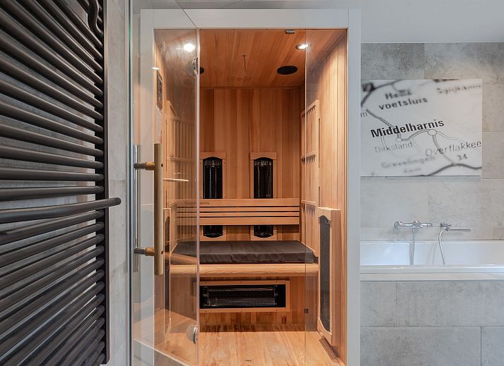 Cozy outdoor area of Bungalow Middelharnis, Ouddorp with shaded area and garden furniture.