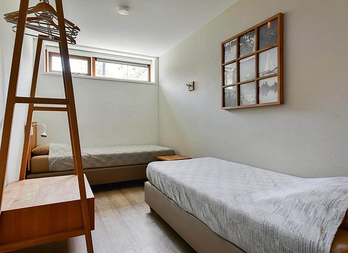 Modern living room of the Detached house in Reeuwijk, vacation home in South Holland with comfortable seating area and plenty of natural light.