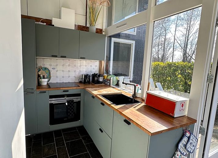 Cozy living room of Holiday home in Reeuwijk overlooking the water, ideally located in the Green Heart of South Holland.