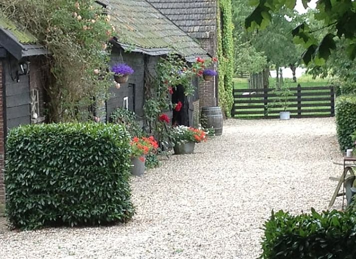 Vakantiehuisje in Vlist, gelegen in het Groene Hart van Zuid-Holland, met een prachtige tuin en schommelbank omringd door natuur.