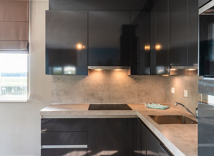 Cozy living room in Chalet in Noordwijk with comfortable sofa and stylish furnishings.