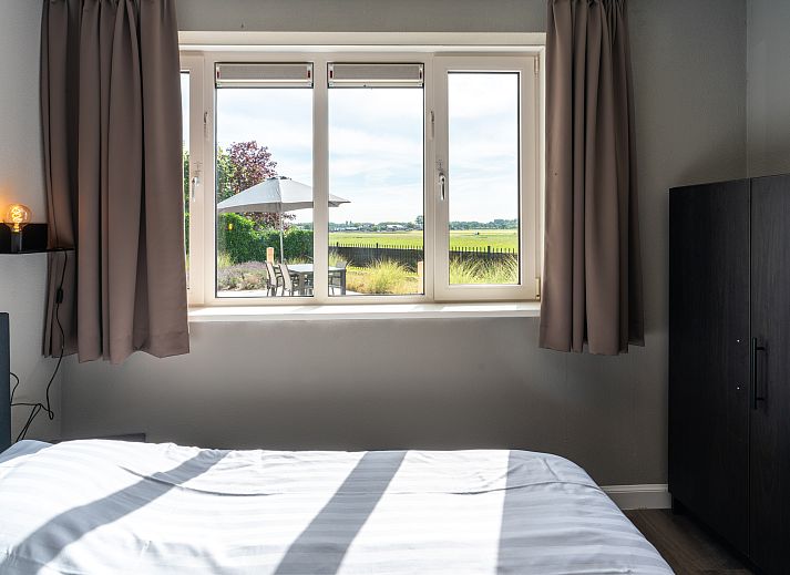 Dining area of Chalet in Noordwijk overlooking nature on the North Sea coast.