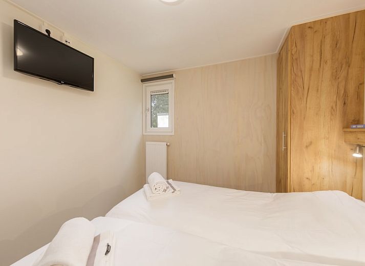 Veranda of Comfort 4 Wellness chalet in Kijkduin, North Sea coast, South Holland overlooking wooded area.