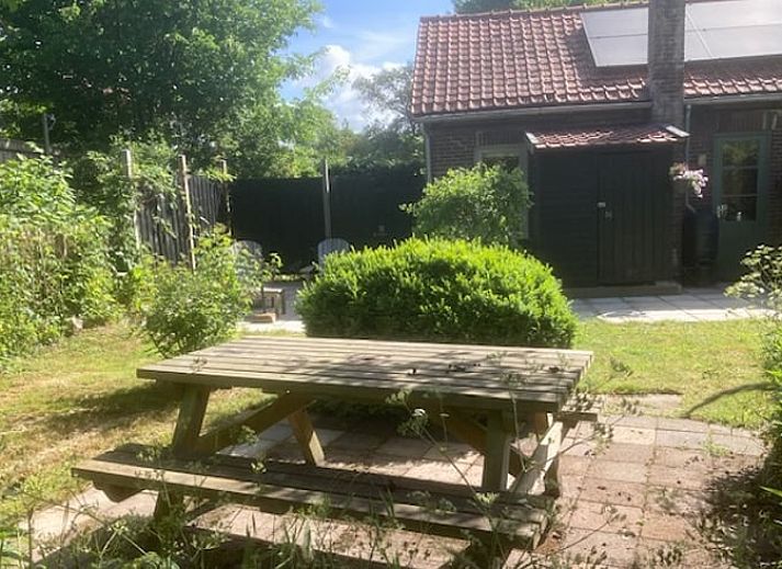 Comfortable sitting area in Holiday home in Oostvoorne, Voorne Putten, overlooking the garden.