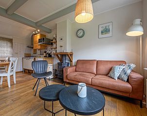 Cozy living room of Kikkertstraat 065, vacation home in De Cocksdorp, Texel, with comfortable seating area.