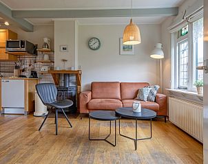 Bright and inviting living space of vacation home Kikkertstraat 065, De Cocksdorp, Texel, with modern furnishings.