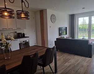 The open kitchen and dining area of Holiday home De Slufter in De Cocksdorp, Texel are ideal for cozy meals.