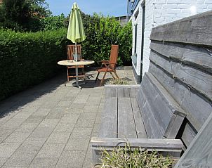 Wooden bench and seat on terrace of Duinviooltje vacation home, De Cocksdorp, Texel.
