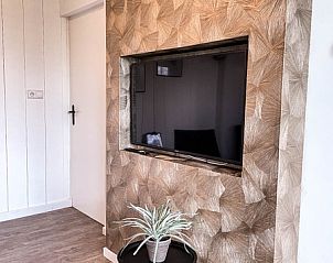 Gezellige woonkamer met tv in Vakantiehuis De Roggesloot, De Cocksdorp, Texel voor ontspanning.