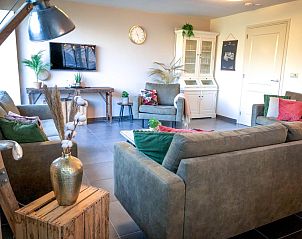 Gemtliches Wohnzimmer im Ferienhaus De Slufter, De Cocksdorp Texel mit bequemen Sofas und modernen Mbeln.