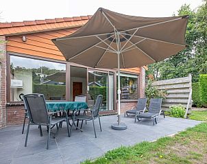 Enjoy the terrace with parasol at Holiday home Slufterhoek 102 in De Cocksdorp, Texel.