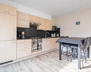 Modern kitchen in Holiday home Slufterhoek 102, De Cocksdorp, Texel with dining area.