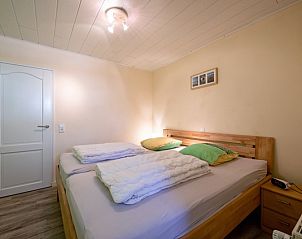 Comfortable bedroom with double bed in Holiday home Slufterhoek 102, De Cocksdorp, Texel.