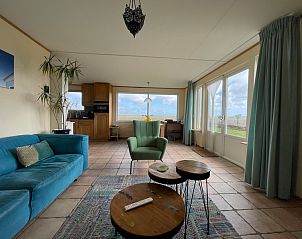 Cozy living room of Vuurtorenweg 58 C in De Cocksdorp Texel overlooking the landscape.