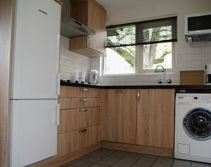 Modern kitchen in 9600 - Daalder - Troost vacation home De Cocksdorp Texel with wooden cabinets and appliances.